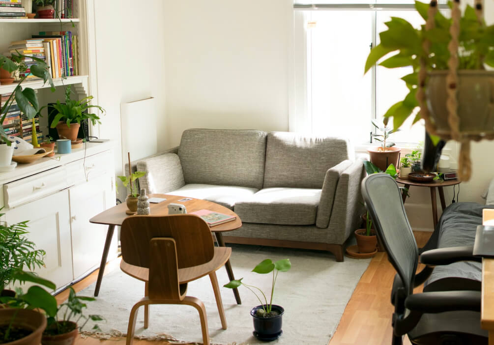 Gray fabric loveseat near brown wooden table